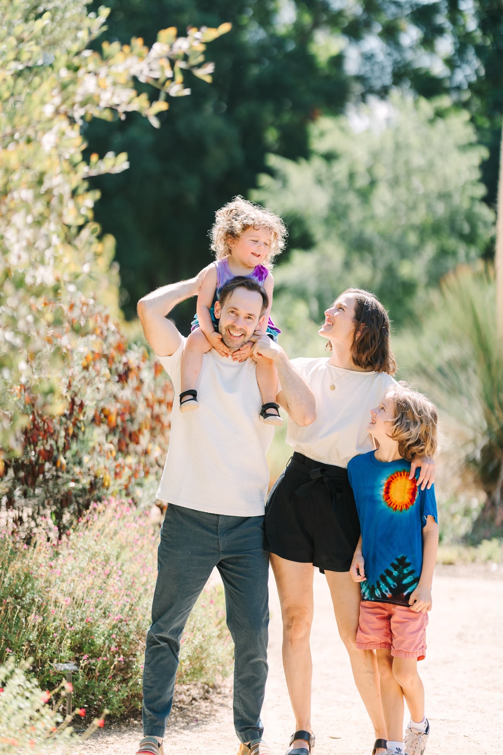 Kurt Wendlenner walking outdoors with his wife and two children
